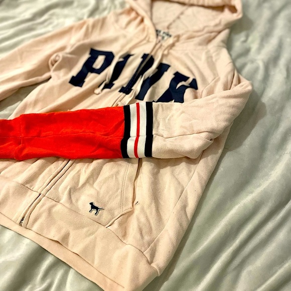 Light pink hoodie with orange and blue stripes on bottom sleeve. - Picture 2 of 3